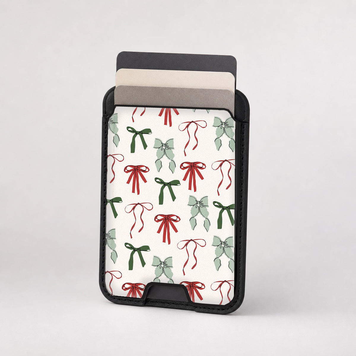 Christmas Bow and Mistletoe MagSafe card holder showing the patterned front