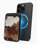 Highland Cowhide Print MagSafe card holder attached to a compatible iPhone