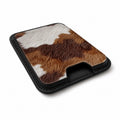 Highland Cowhide Print MagSafe card holder showing the angled leather surface