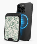 Green Toile Botanical MagSafe card holder attached to a compatible iPhone