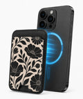 Black Cream Oversized Floral MagSafe card holder attached to a compatible iPhone
