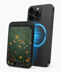 Dark Green Golden Wildflower Meadow MagSafe card holder attached to a compatible iPhone