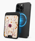 Pressed Wildflower Bouquet MagSafe card holder attached to a compatible iPhone