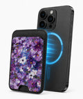 Purple Watercolor Flower Field MagSafe card holder attached to a compatible iPhone