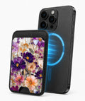 Purple Wildflower Glass Garden MagSafe card holder attached to a compatible iPhone