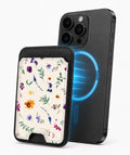 Delicate Mixed Wildflower MagSafe card holder attached to a compatible iPhone
