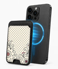 Black White Doodle Floral MagSafe card holder attached to a compatible iPhone