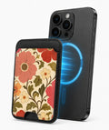 Coral Retro Folk Floral MagSafe card holder attached to a compatible iPhone
