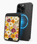 Pressed Daisy Wildflower Bouquet MagSafe card holder attached to a compatible iPhone
