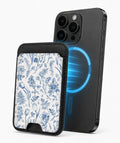 Blue Toile Wildflower MagSafe card holder attached to a compatible iPhone