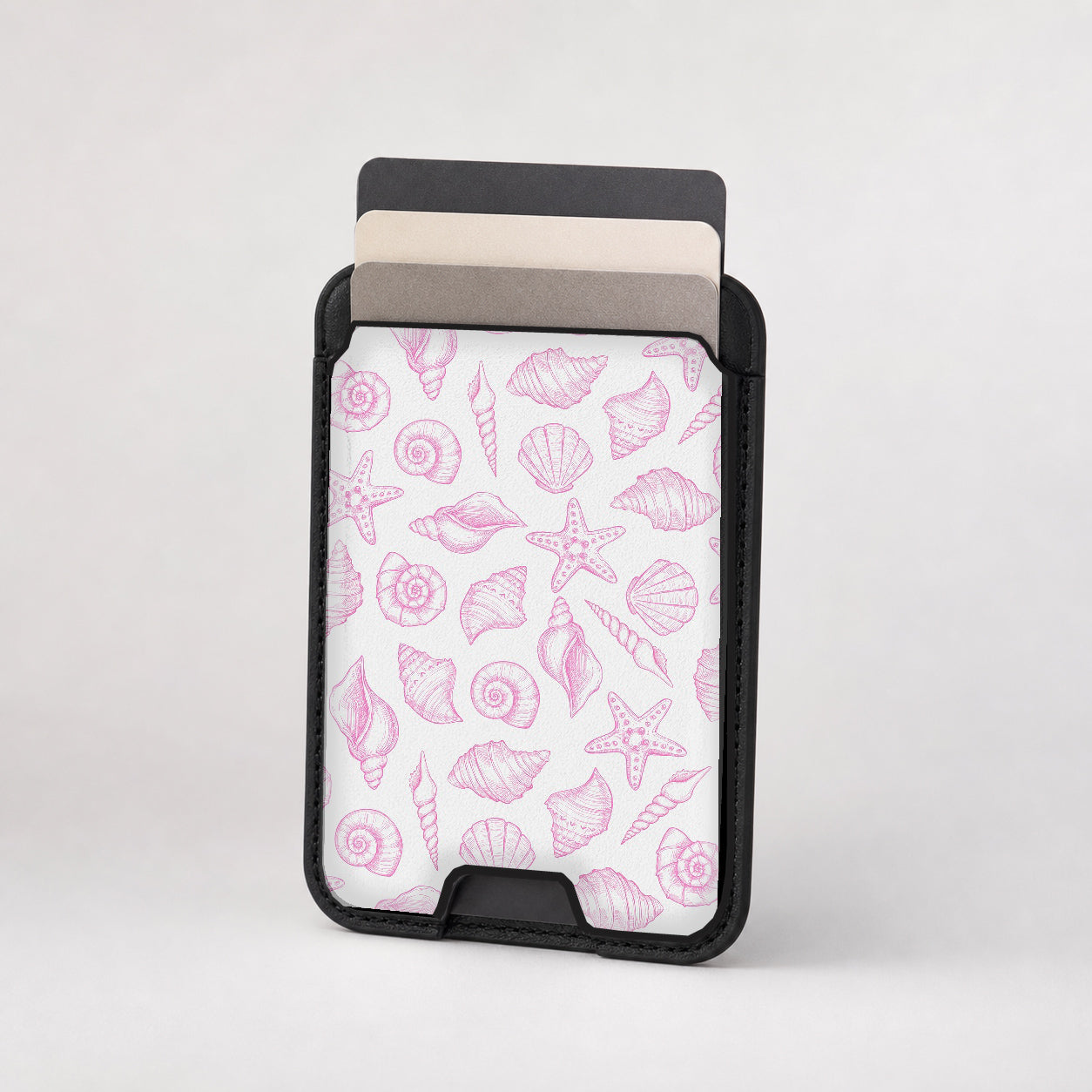 Third view of the Pink Coastal Seashell MagSafe Card Holder MagSafe card holder featuring the patterned front