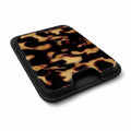 Tortoiseshell MagSafe card holder showing the angled leather surface