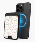 Pink Ditsy Floral MagSafe card holder attached to a compatible iPhone
