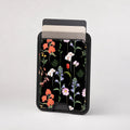 Black Wildflower Meadow MagSafe card holder showing the patterned front