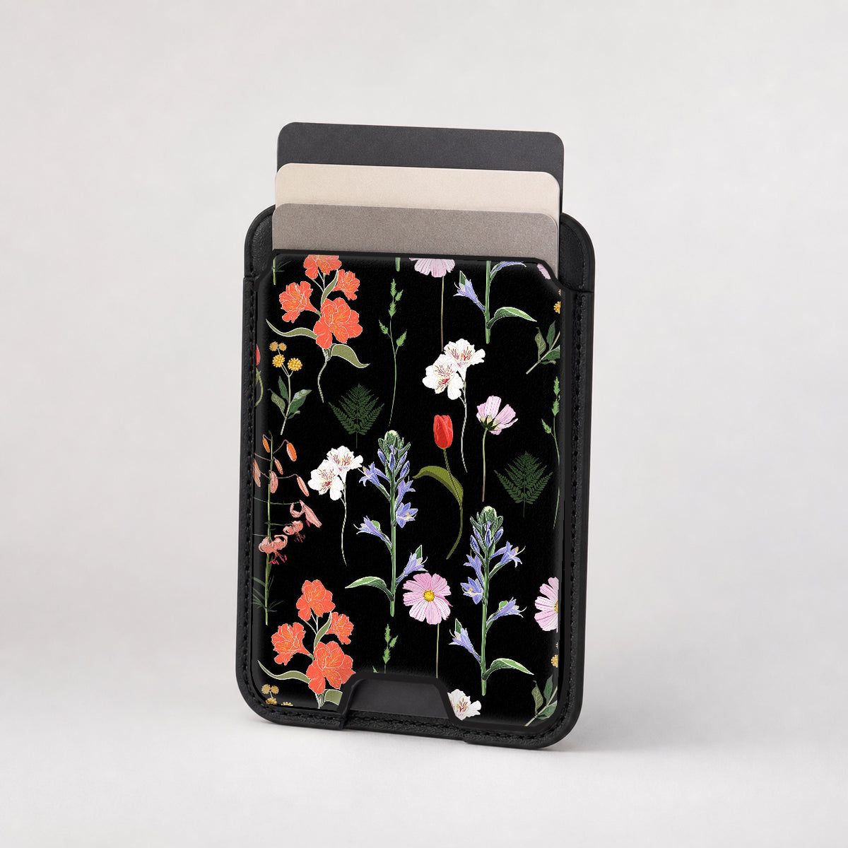 Black Wildflower Meadow MagSafe card holder showing the patterned front