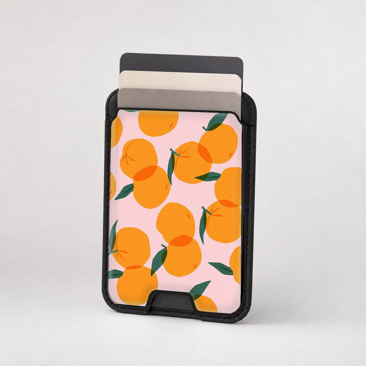 Orange Fruit on Pink MagSafe card holder showing the patterned front
