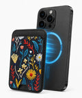 Navy Embroidered Wildflower MagSafe card holder attached to a compatible iPhone