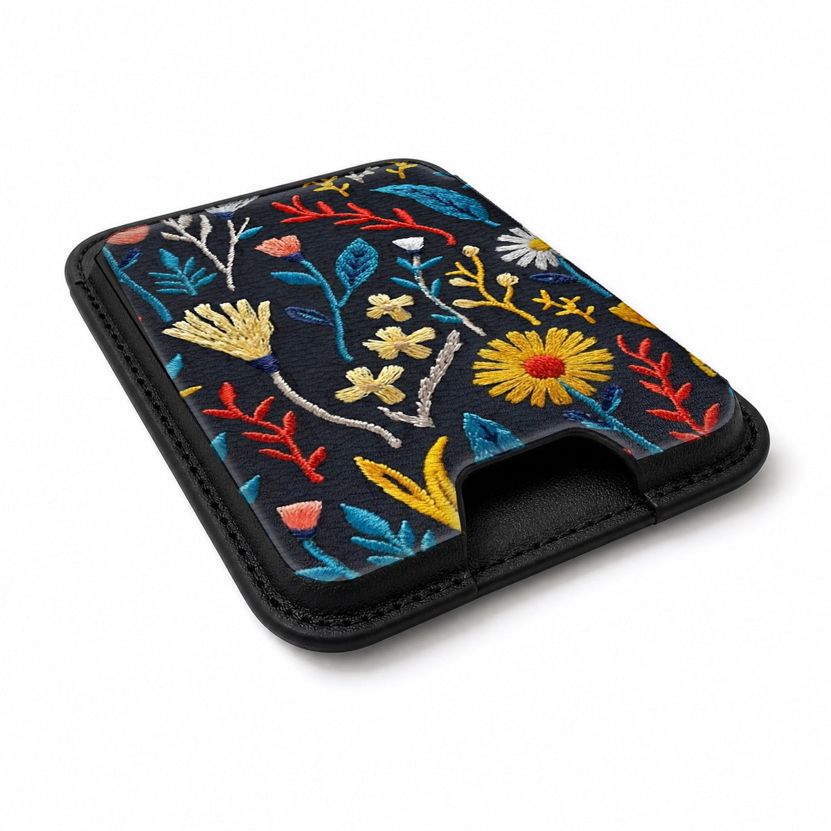 Navy Embroidered Wildflower MagSafe card holder showing the angled leather surface