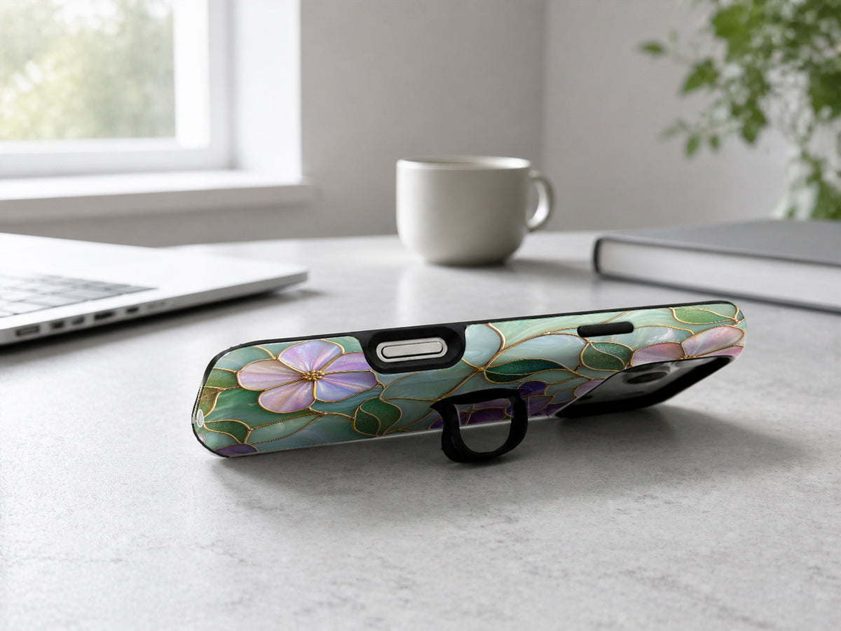 Aqua Grape Stained Glass Floral MagSafe Loop iPhone Case shown in a neutral white professional lifestyle setting