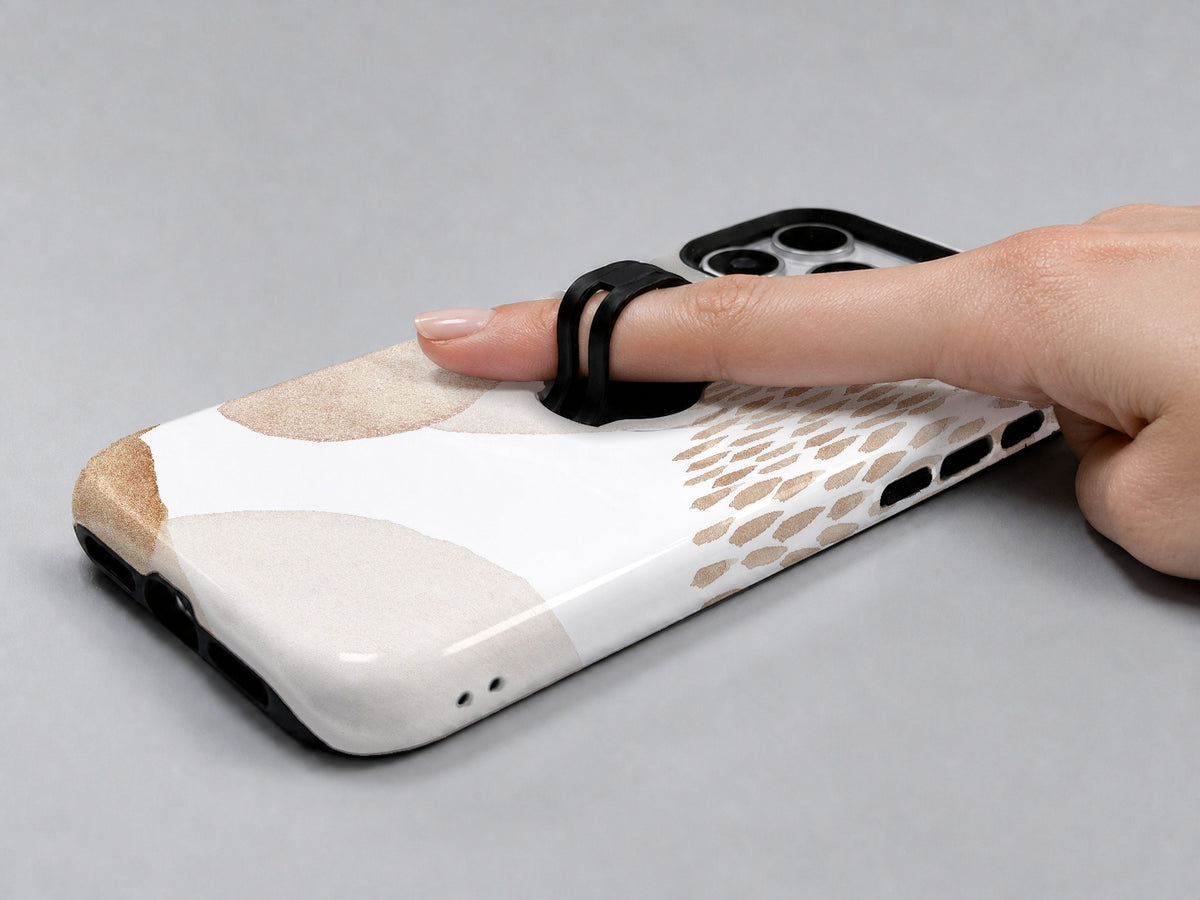 Beige Abstract Pebble MagSafe Loop iPhone Case shown in use with a finger through the horizontal loop