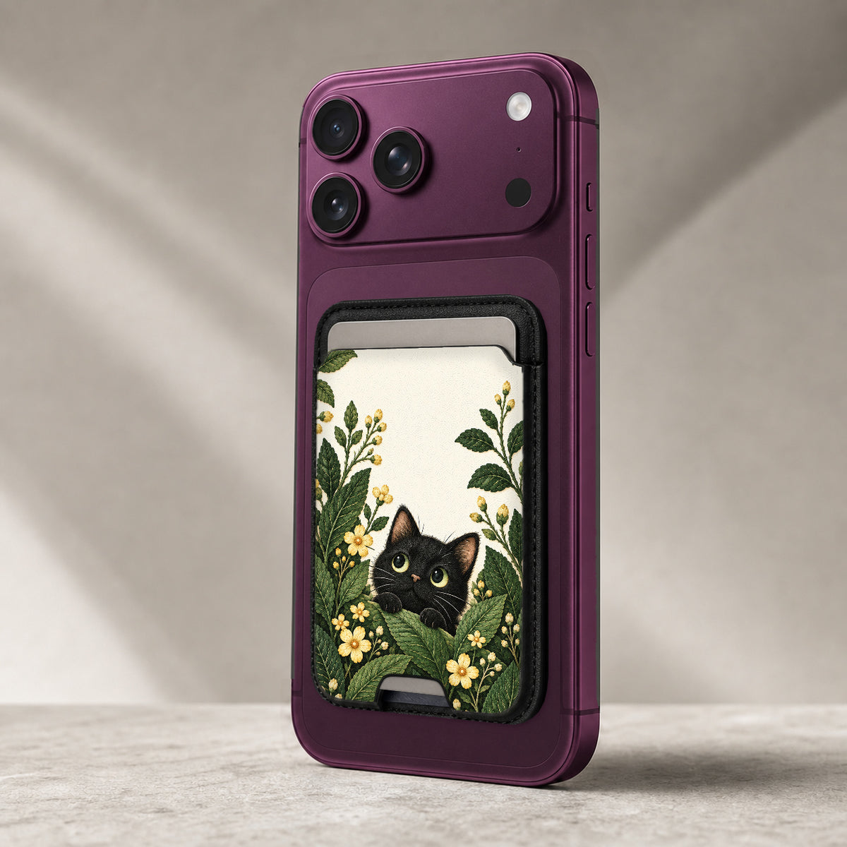 Black Cat Botanical Garden MagSafe Card Holder, attached to the back of a compatible phone