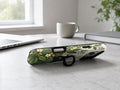 Black Cat Botanical Garden MagSafe Loop iPhone Case, shown as a kickstand on a desk