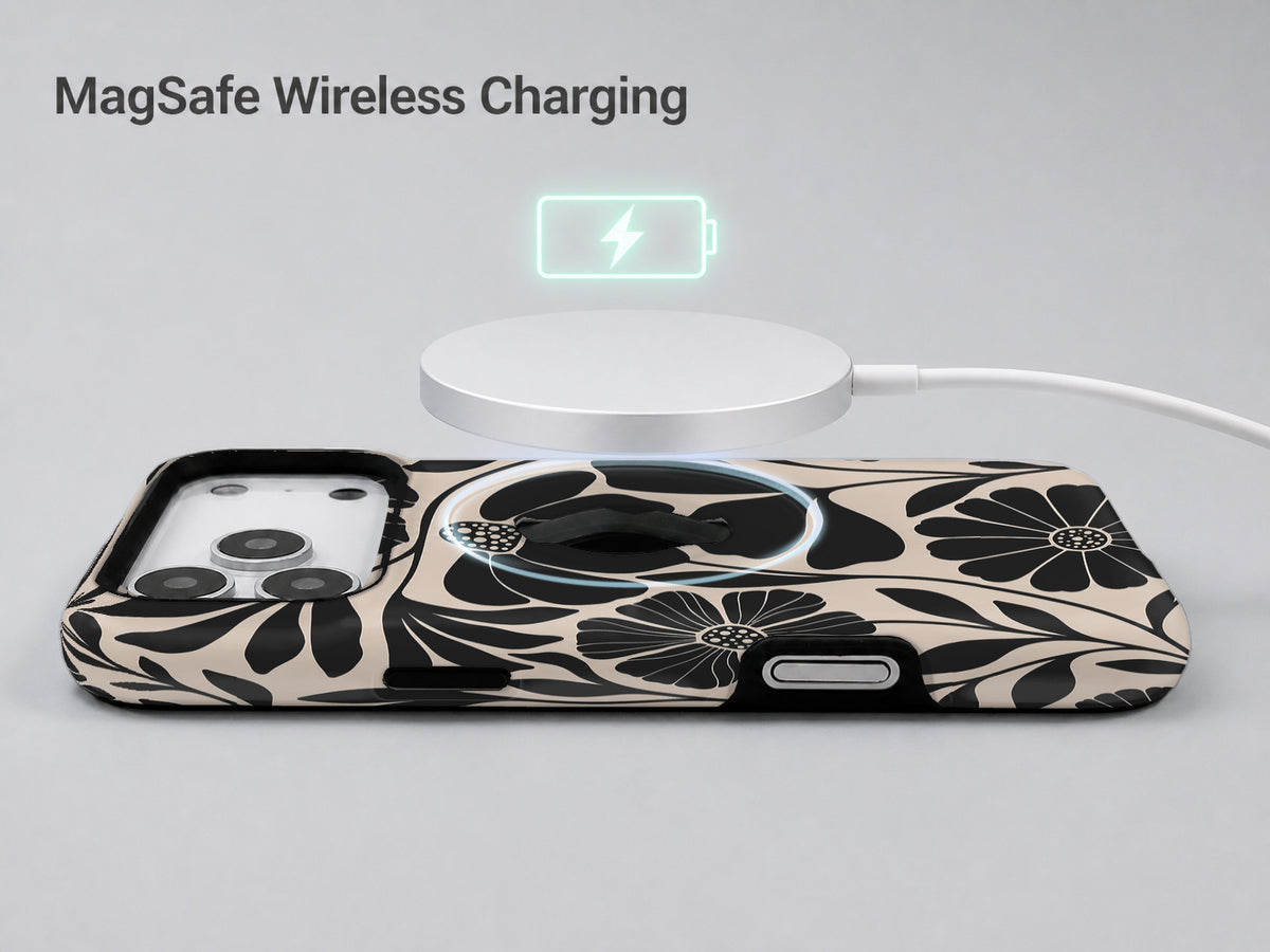 Black Cream Bold Floral MagSafe Loop iPhone Case shown with a MagSafe-compatible wireless charger attached