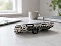 Black Cream Bold Floral MagSafe Loop iPhone Case shown in a neutral white professional lifestyle setting