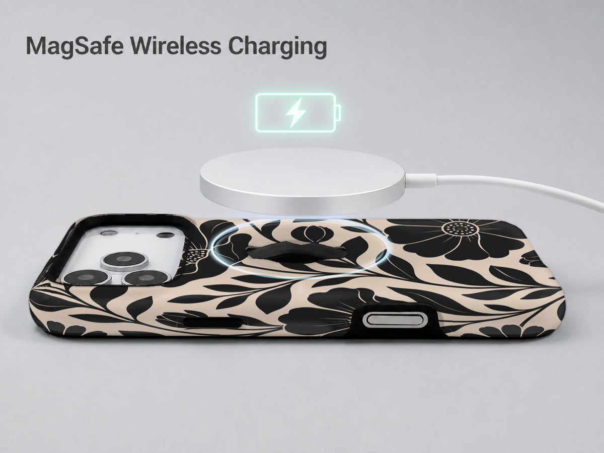 Black Cream Oversized Floral MagSafe Loop iPhone Case shown with a MagSafe-compatible wireless charger attached