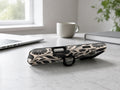 Black Cream Oversized Floral MagSafe Loop iPhone Case shown in a neutral white professional lifestyle setting
