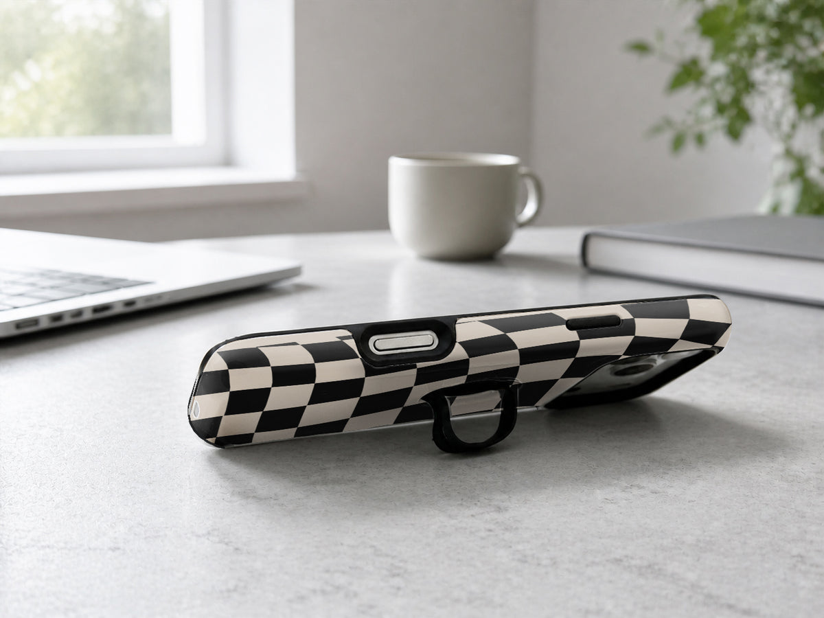 Black Cream Wavy Checkerboard MagSafe Loop iPhone Case shown in a neutral white professional lifestyle setting