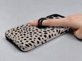 Black Dalmatian Spot MagSafe Loop iPhone Case shown in use with a finger through the horizontal loop