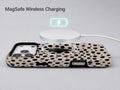 Black Dalmatian Spot MagSafe Loop iPhone Case shown with a MagSafe-compatible wireless charger attached