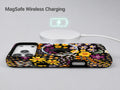 Black Folk Garden Floral MagSafe Loop iPhone Case shown with a MagSafe-compatible wireless charger attached