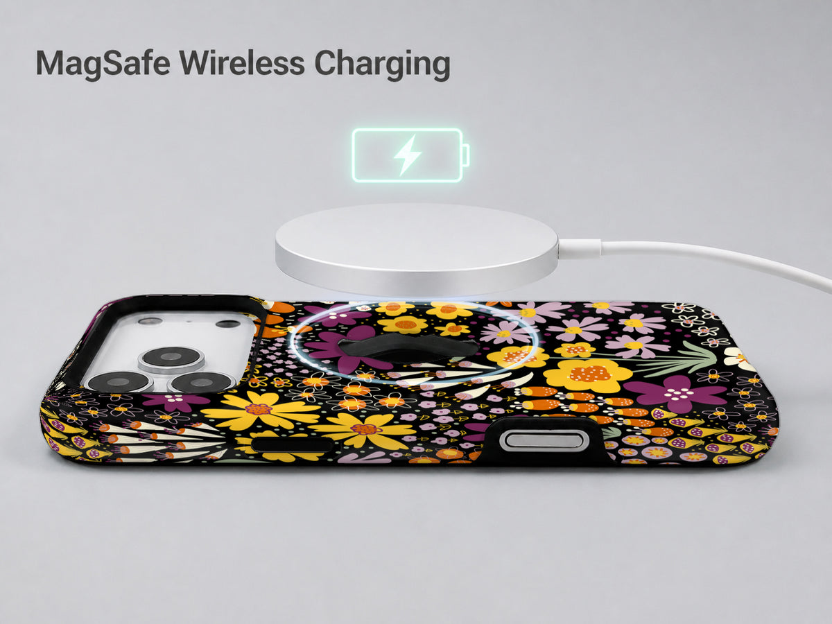 Black Folk Garden Floral MagSafe Loop iPhone Case shown with a MagSafe-compatible wireless charger attached