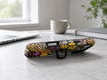 Black Folk Garden Floral MagSafe Loop iPhone Case shown in a neutral white professional lifestyle setting