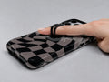 Black Taupe Wavy Checkerboard MagSafe Loop iPhone Case shown in use with a finger through the horizontal loop