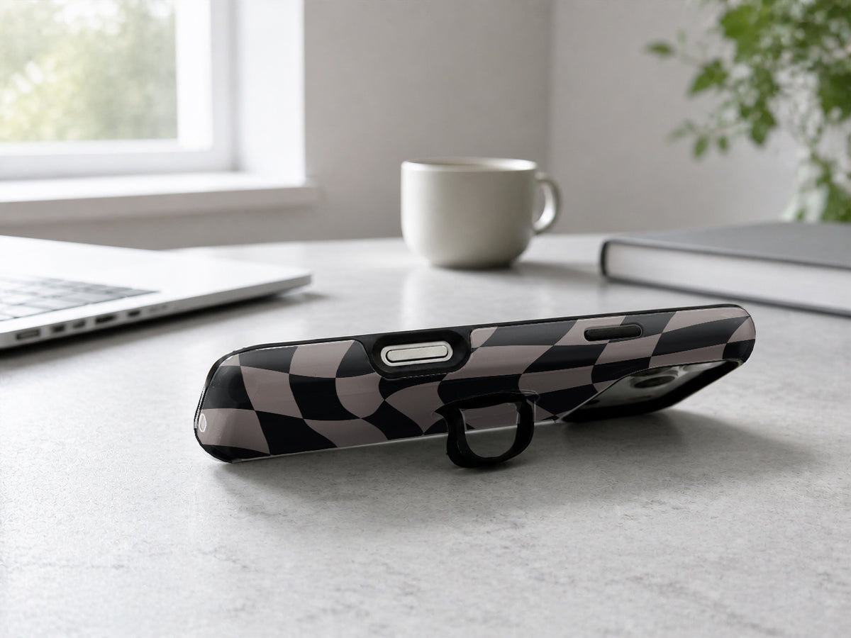 Black Taupe Wavy Checkerboard MagSafe Loop iPhone Case shown in a neutral white professional lifestyle setting