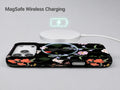 Black Wildflower Meadow MagSafe Loop iPhone Case shown with a MagSafe-compatible wireless charger attached