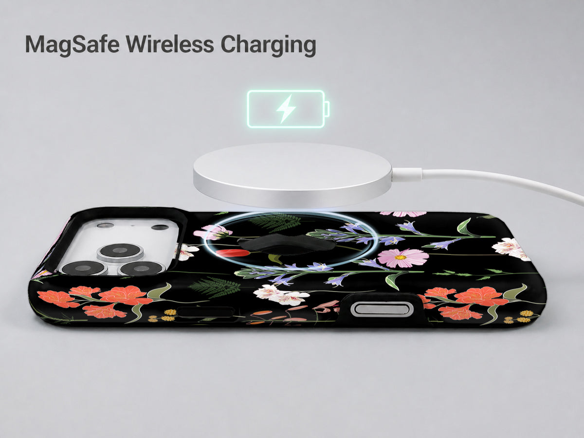Black Wildflower Meadow MagSafe Loop iPhone Case shown with a MagSafe-compatible wireless charger attached