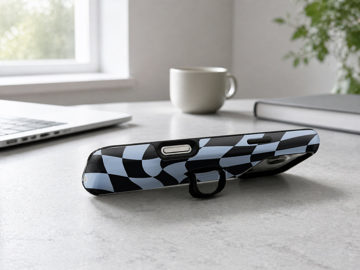 Blue Black Wavy Checkerboard MagSafe Loop iPhone Case shown in a neutral white professional lifestyle setting