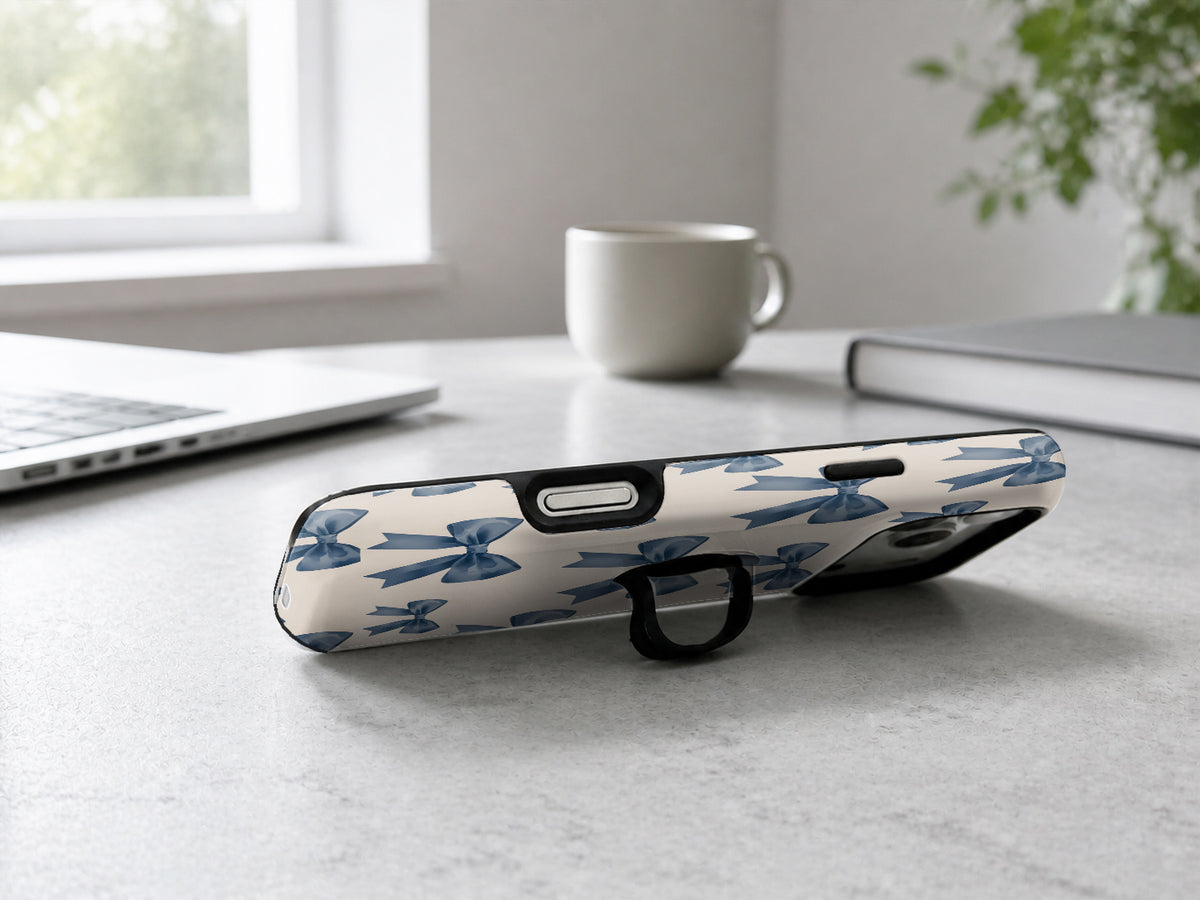 Blue Coquette Bow MagSafe Loop iPhone Case shown in a neutral white professional lifestyle setting