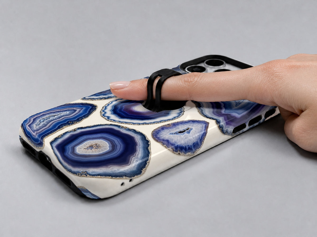 Blue Purple Agate Geode MagSafe Loop iPhone Case shown in use with a finger through the horizontal loop
