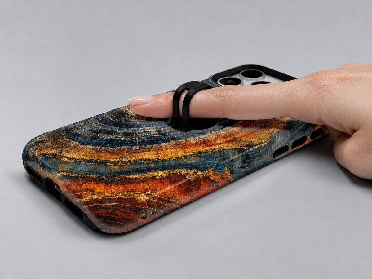 Blue Tiger Eye Stone MagSafe Loop iPhone Case shown in use with a finger through the horizontal loop