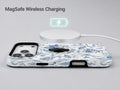 Blue Toile Wildflower MagSafe Loop iPhone Case shown with a MagSafe-compatible wireless charger attached