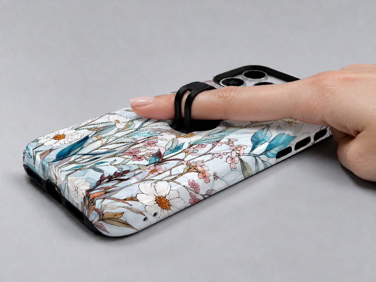 Blue White Daisy Wildflower MagSafe Loop iPhone Case shown in use with a finger through the horizontal loop