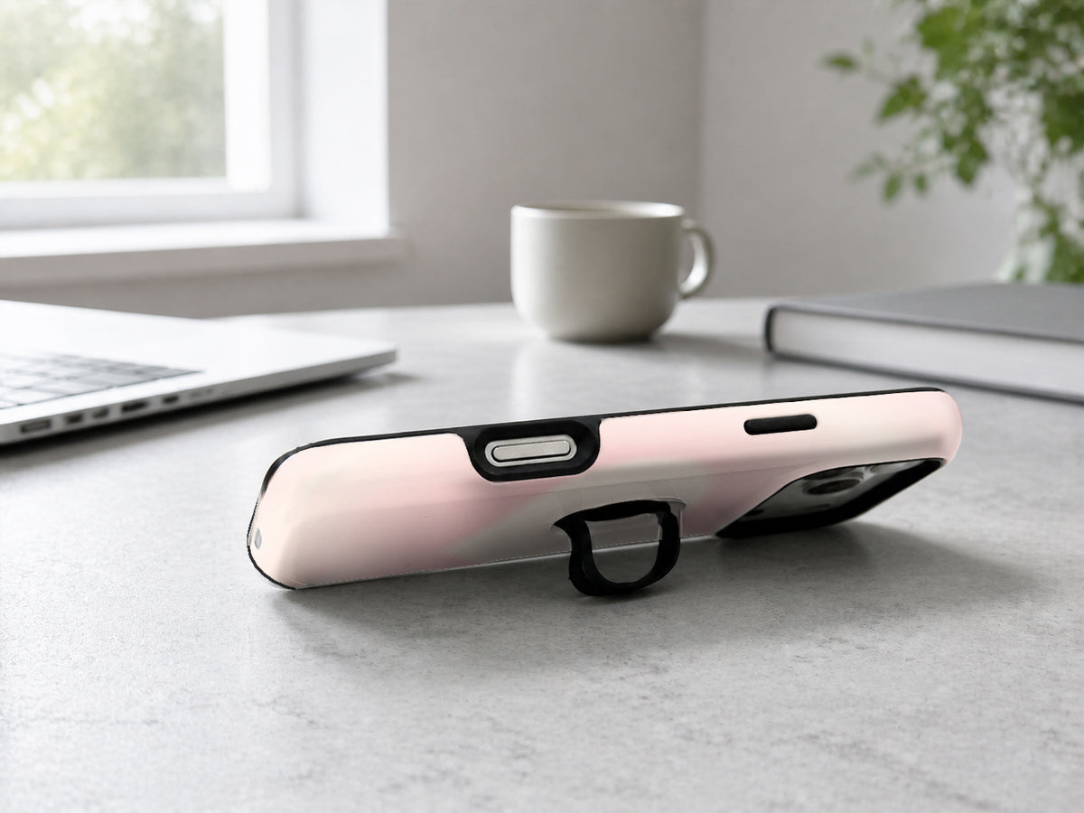 Blush Pink Abstract Gradient MagSafe Loop iPhone Case shown in a neutral white professional lifestyle setting