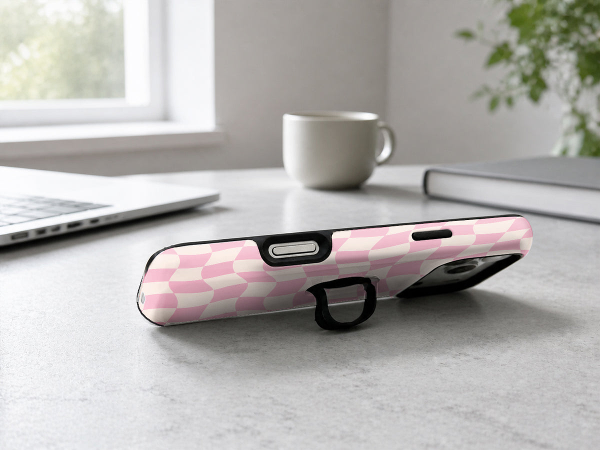 Blush Pink Checkerboard MagSafe Loop iPhone Case shown in a neutral white professional lifestyle setting