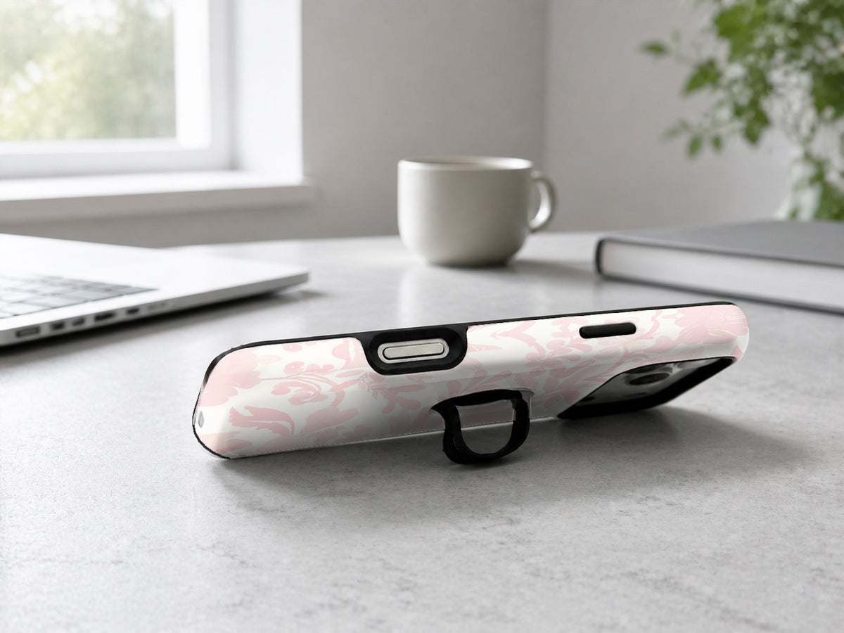 Blush Pink Chinoiserie Floral MagSafe Loop iPhone Case shown in a neutral white professional lifestyle setting