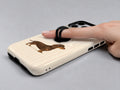 Brown Dachshund on Cream Pinstripes MagSafe Loop Case, shown with a finger through the loop